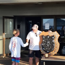 Olie Stone being presented with the Wiahu Shield by P Class and TYPBC Stalwart Gary Smith
