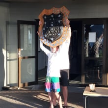 Olie Stone holding the Wihau Shield aloft